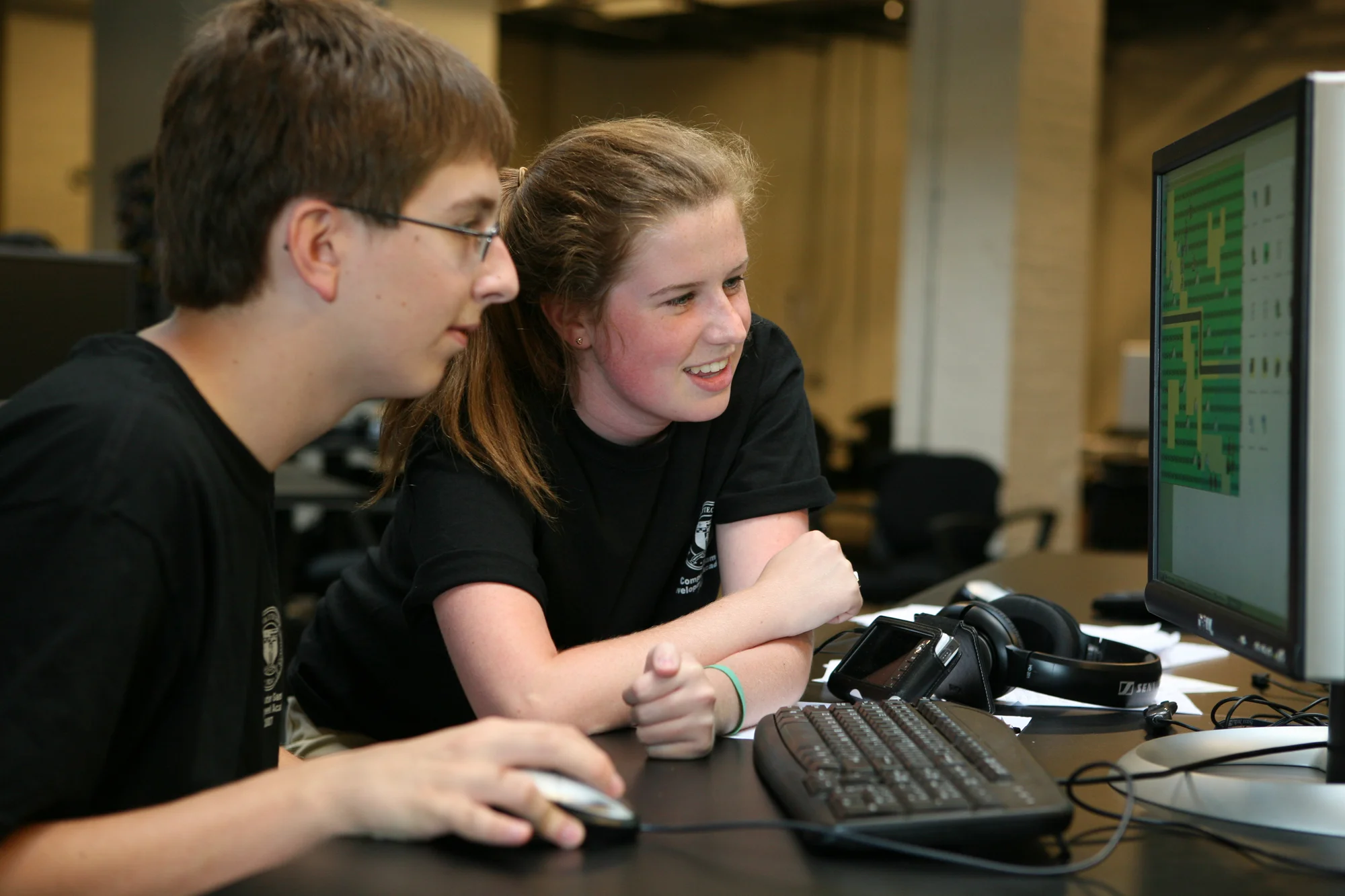 Two students in front of a computer