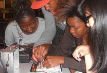 Four students doing a hands on electronics project
